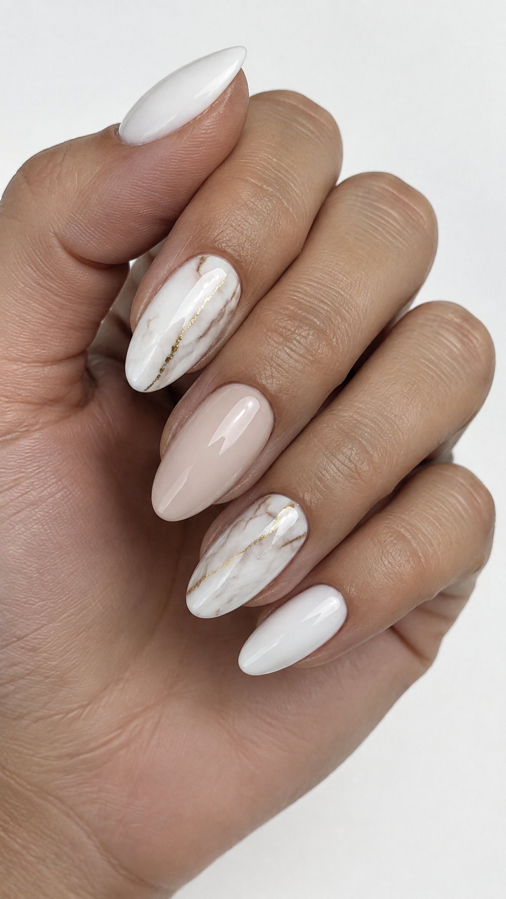 Glossy white, nude, and gold-veined marble manicure