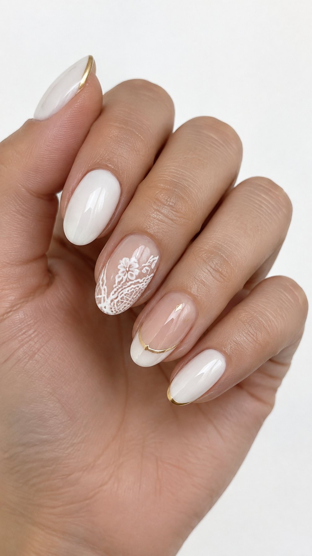 Glossy white lace-patterned nails and delicate gold accents