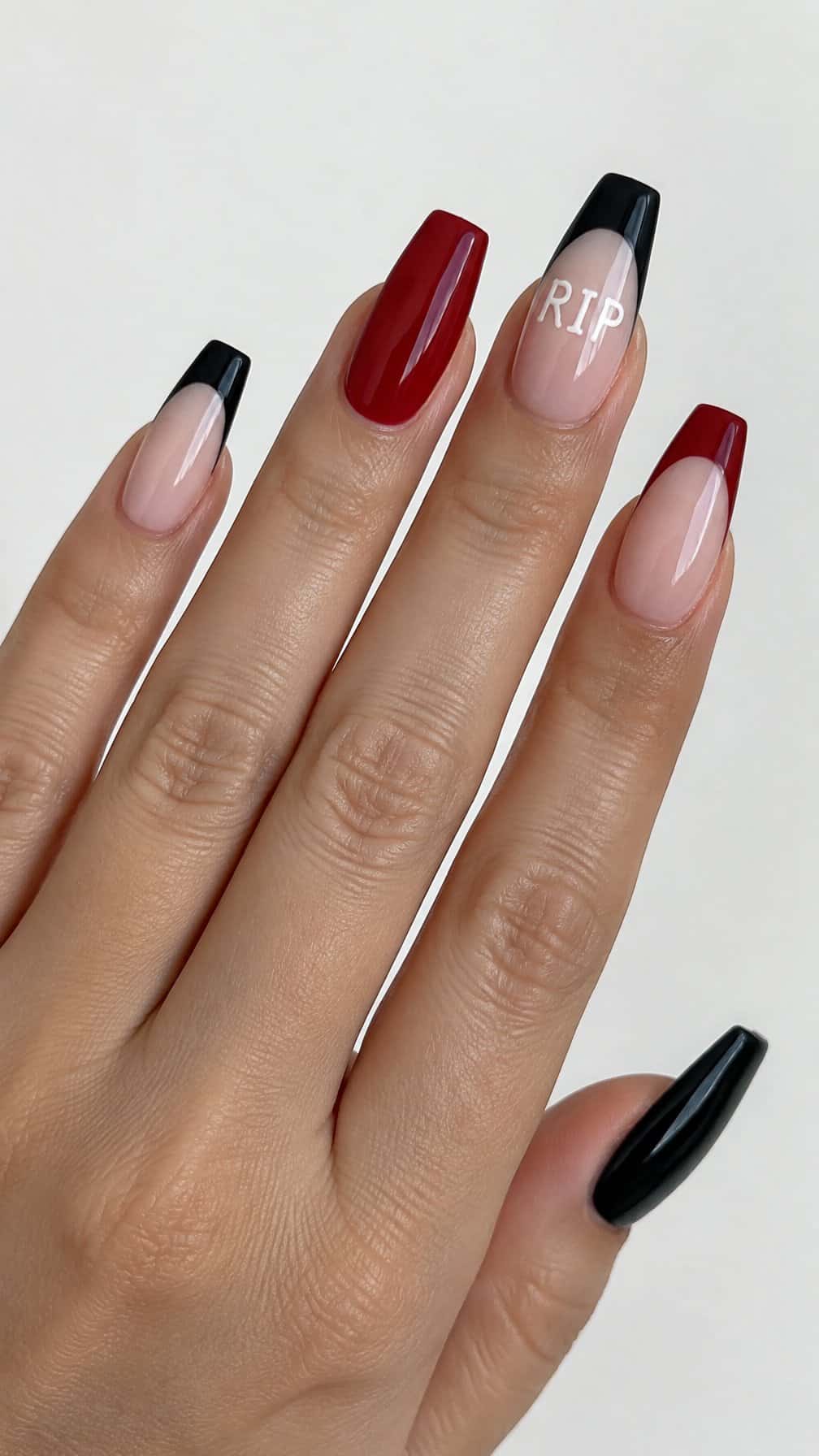 Glossy coffin-shaped Halloween French-tip nails in black, red, and ivory