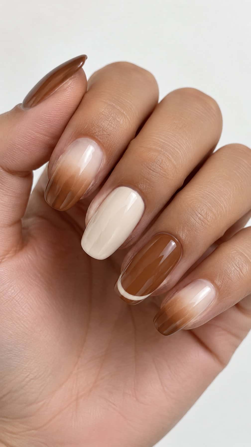 Glossy brown and cream ombré manicure nails