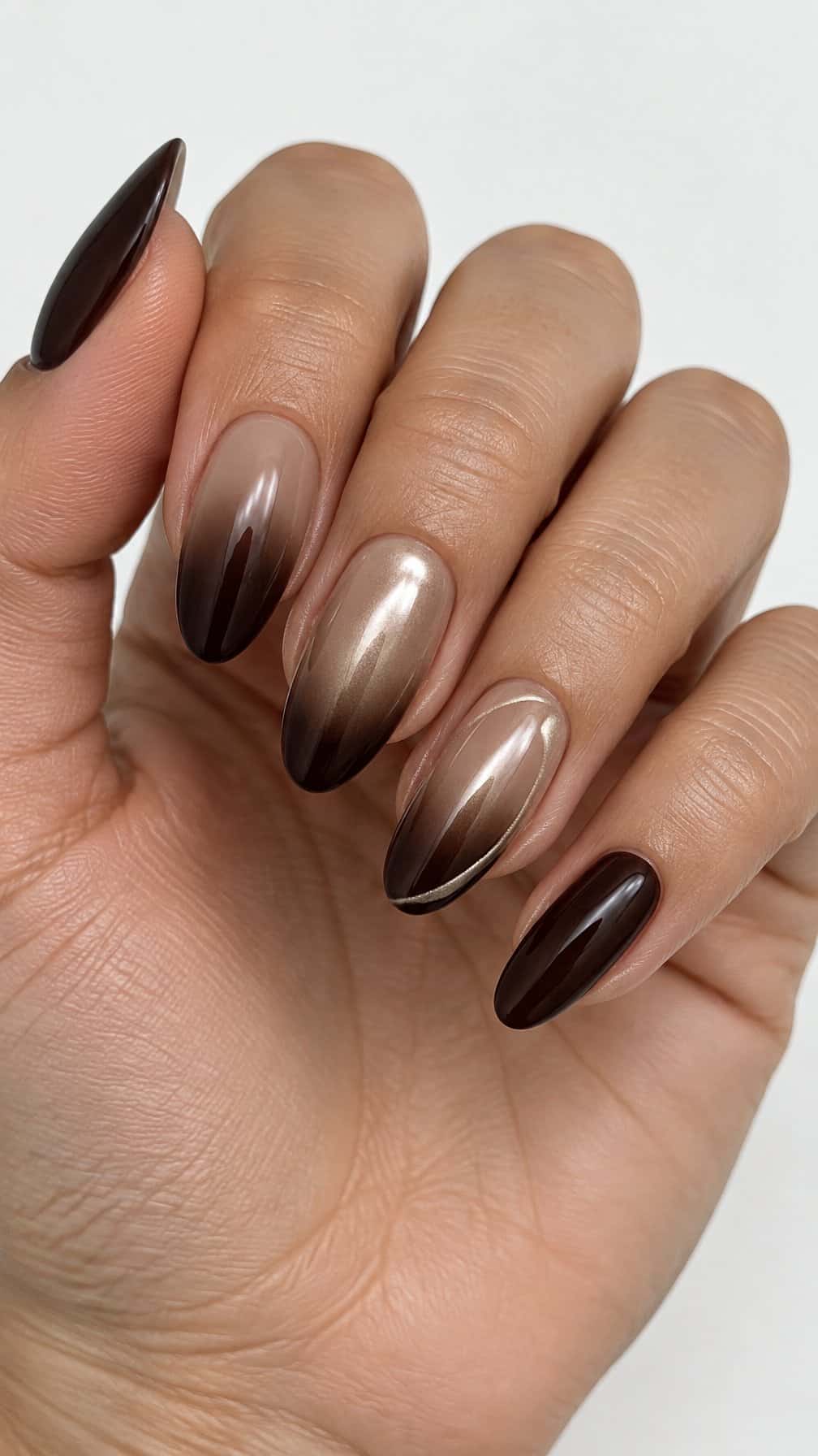 Glossy dark brown ombré nails and subtle pearly accents