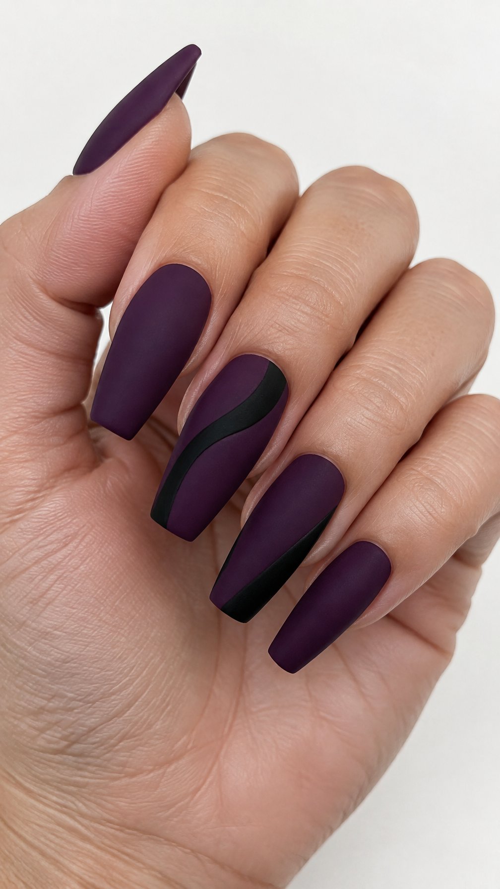 Dark purple coffin-shaped manicure with black accents