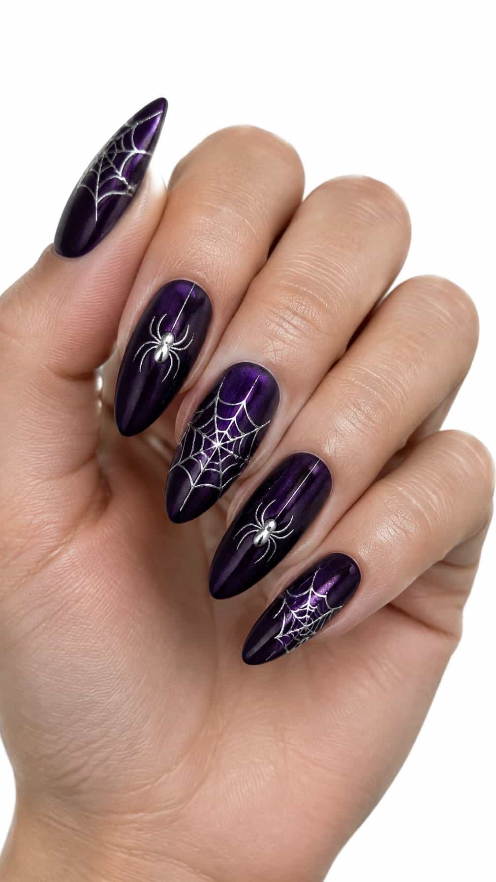 Dark purple velvet nails decorated with delicate silver spiders and spiderwebs