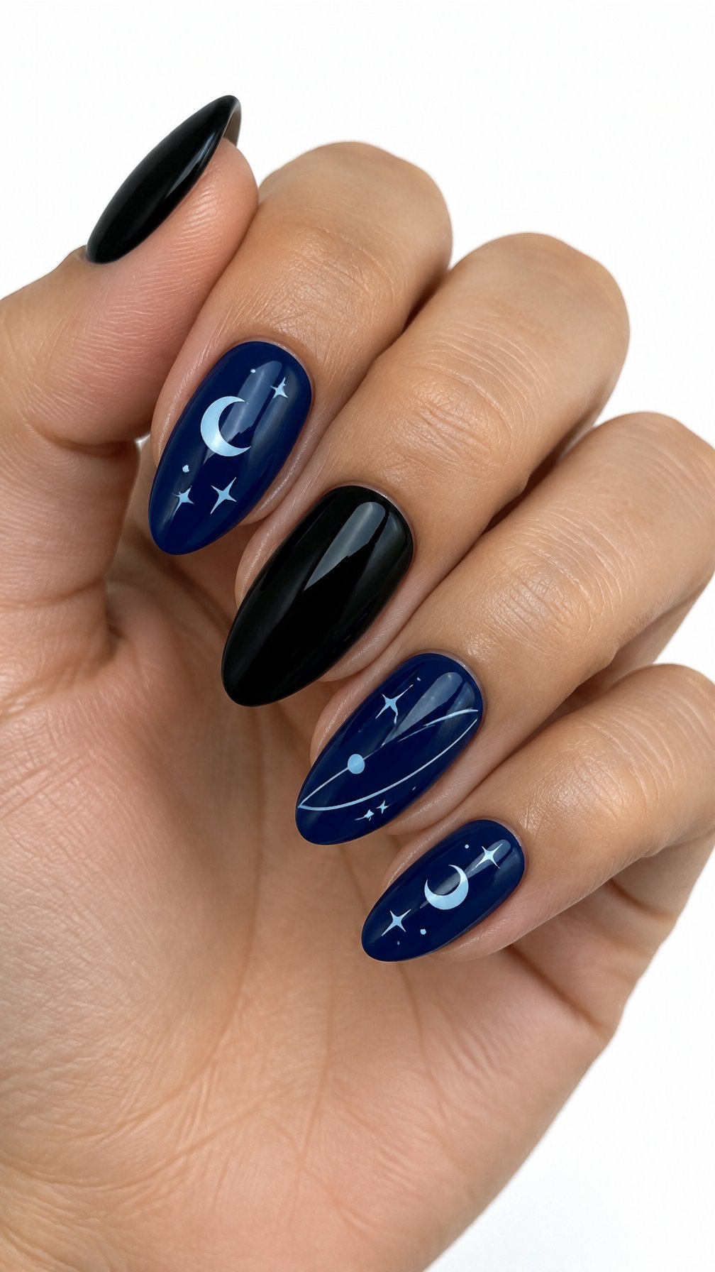 Glossy black and navy nails decorated with crescent moons and small stars
