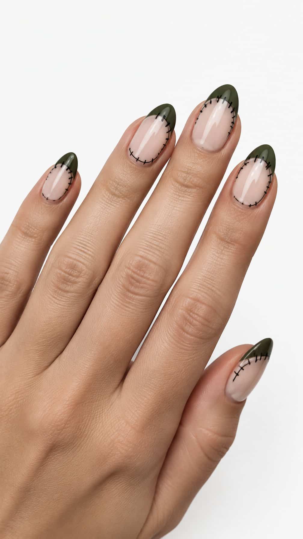 Green French-tip nails decorated with black stitch designs