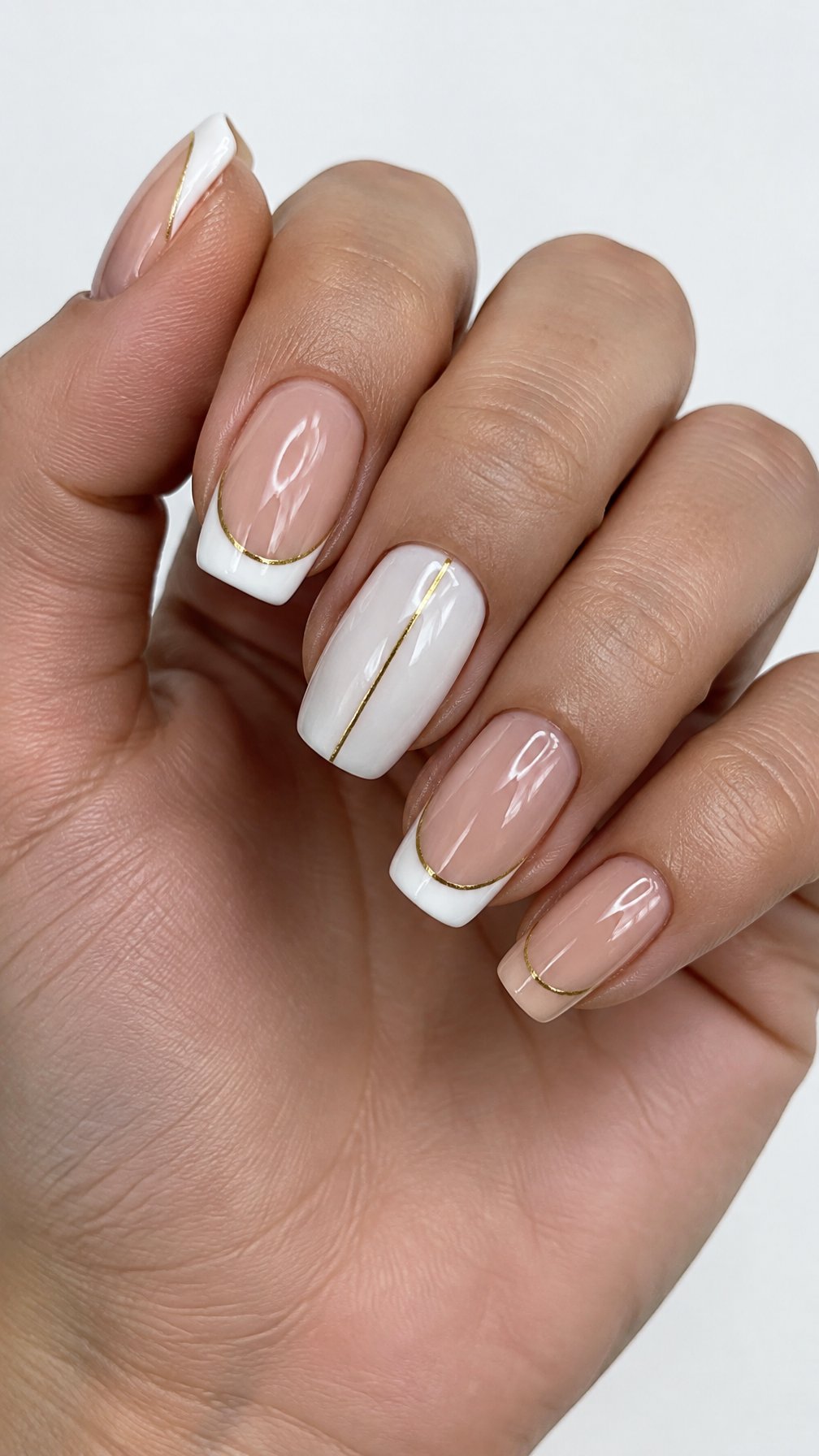 Glossy white French-tip nails outlined in gold