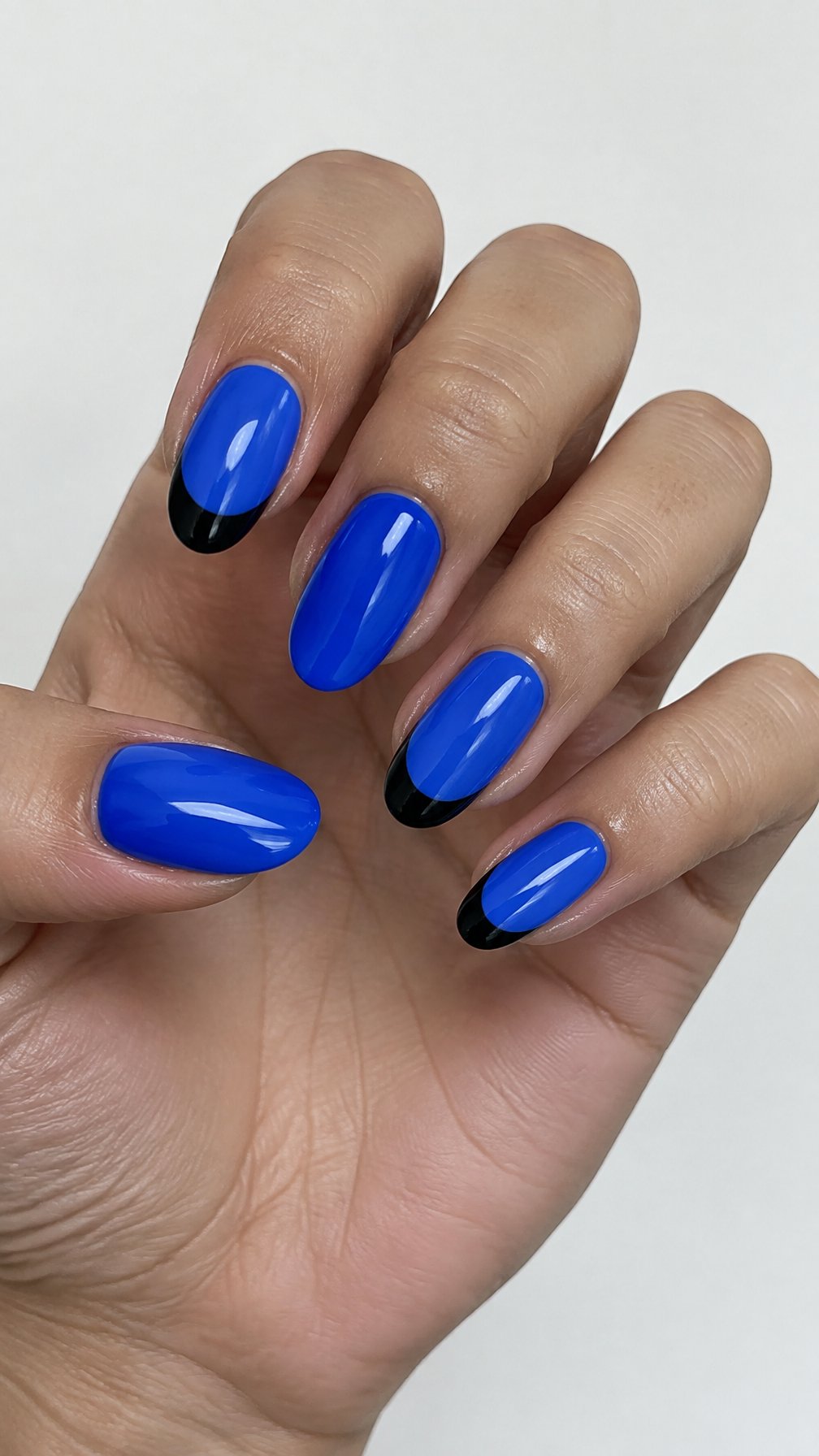Glossy electric blue nails and black French tips rests