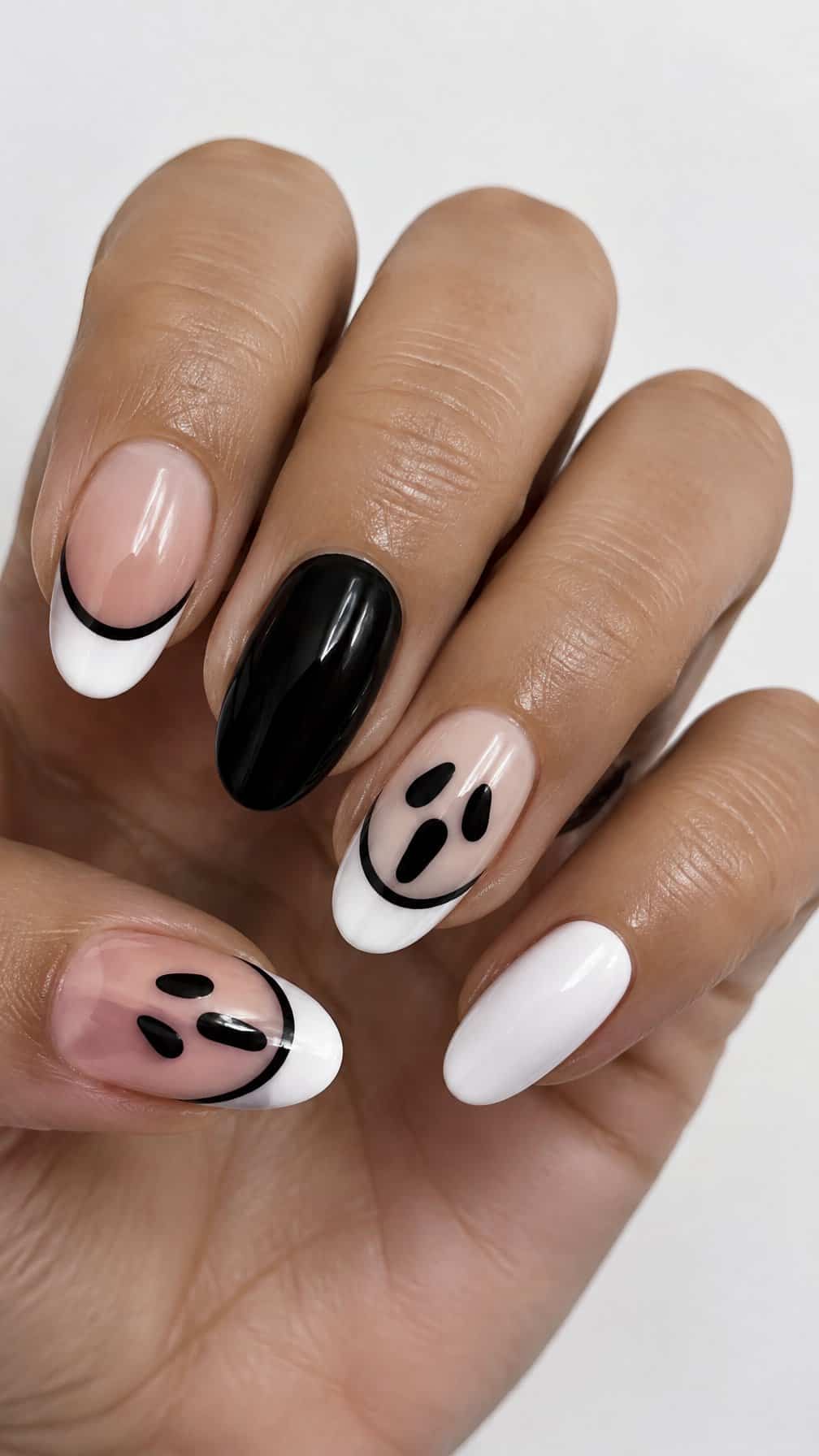 Glossy black-and-white Halloween-themed French-tip nails