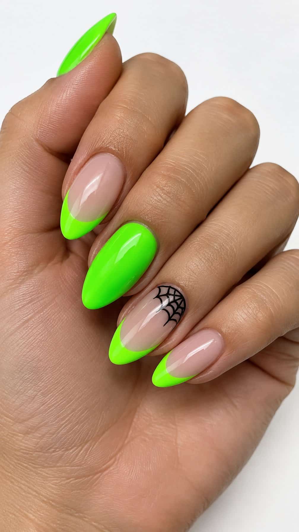 Glossy neon green French tip nails and simple black Halloween accents
