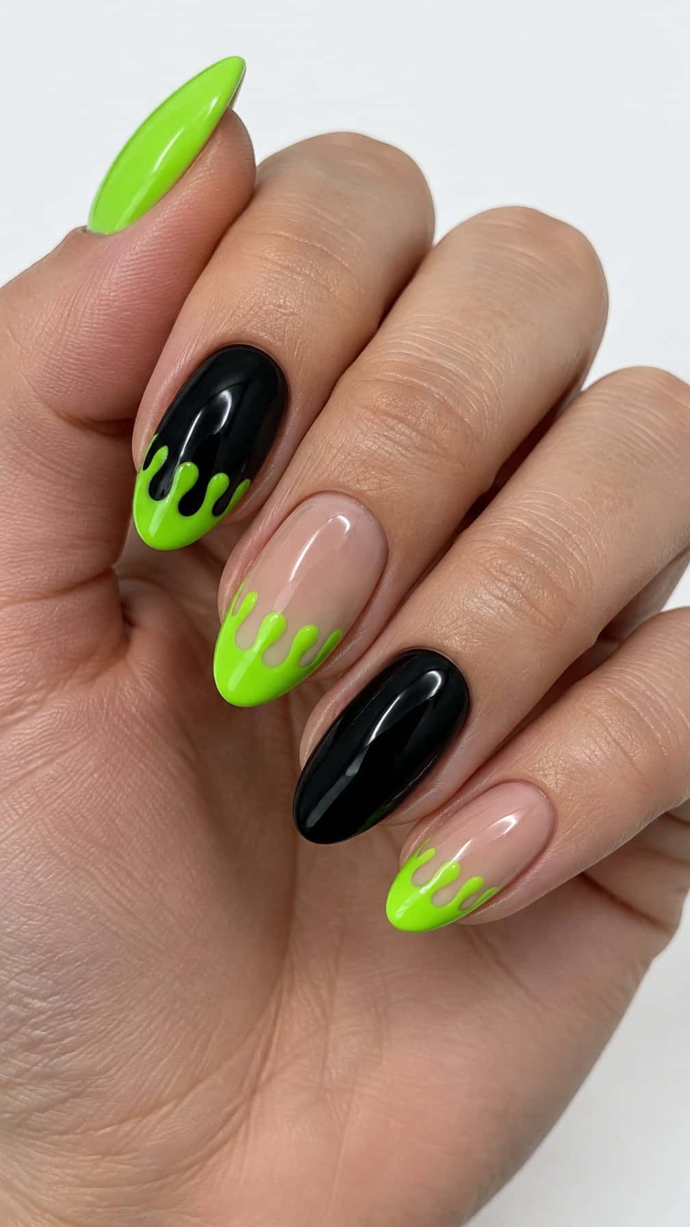Glossy black and bright green Halloween-themed manicure designs