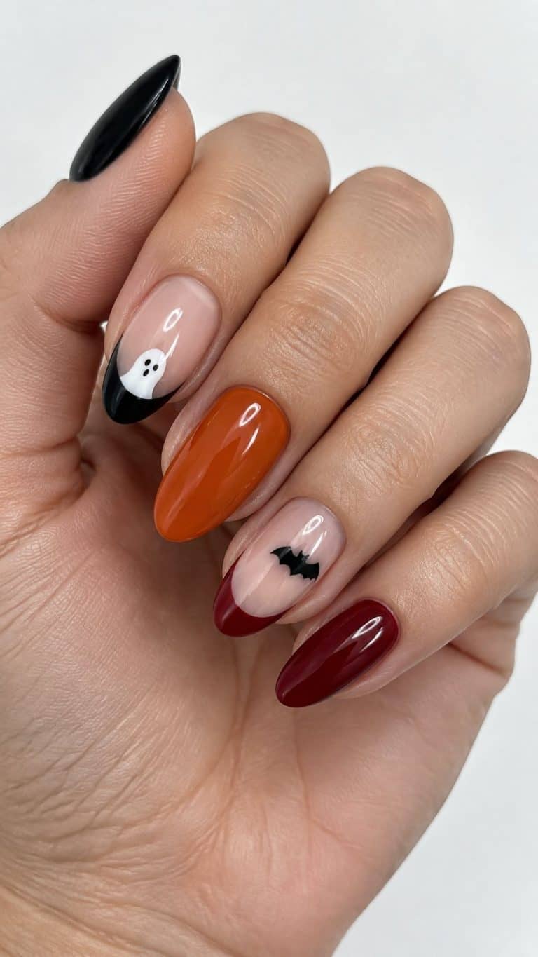 Glossy black, orange, red, and white Halloween-themed nail designs