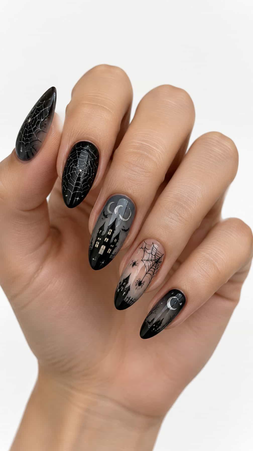 Black and gray spider web and haunted house designs painted on the nails