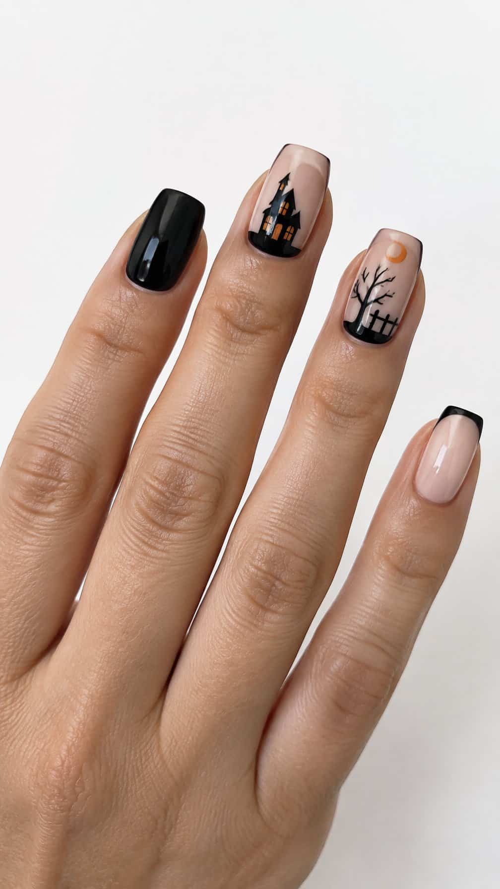 Glossy Halloween-themed French tip nails featuring dark haunted house silhouettes