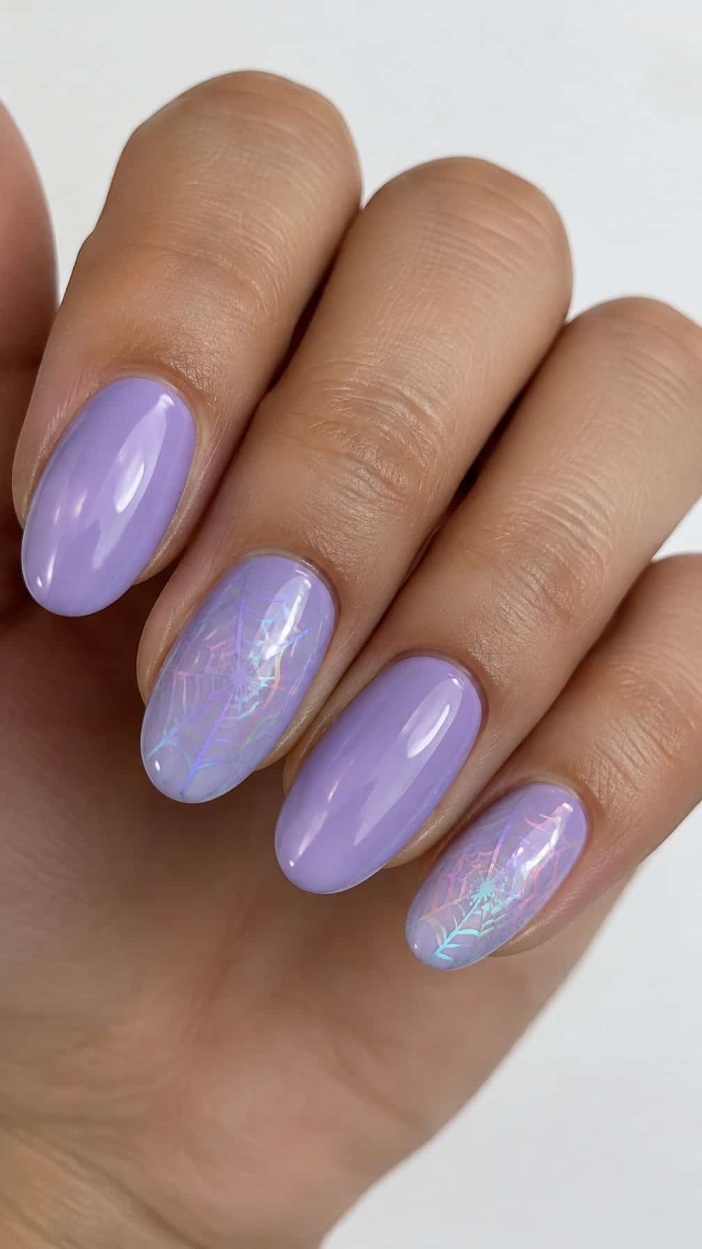 Lavender gel nails and delicate iridescent spider-web designs