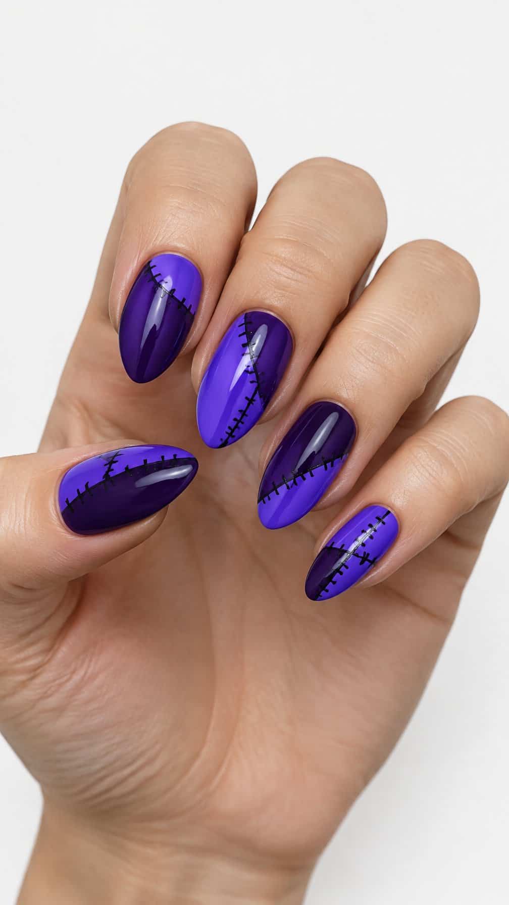 Purple nails decorated with black stitched designs