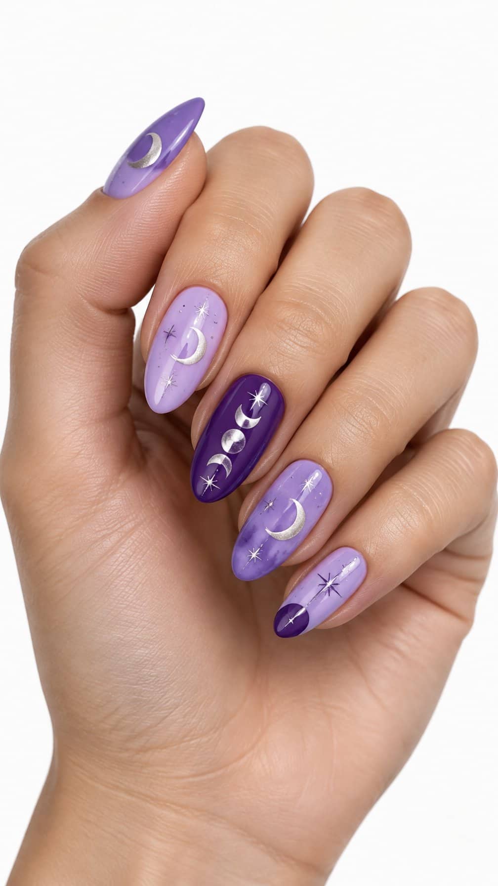 Glossy lilac and purple nails decorated with crescent moons, stars, and moon phases