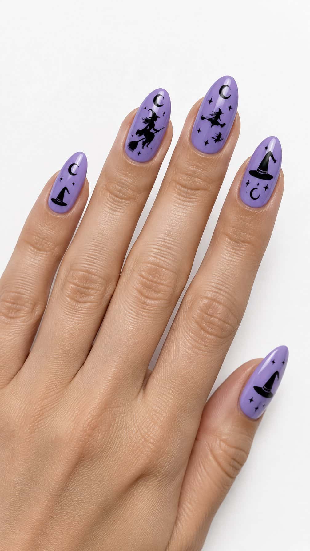 Glossy lilac nails decorated with black witch silhouettes