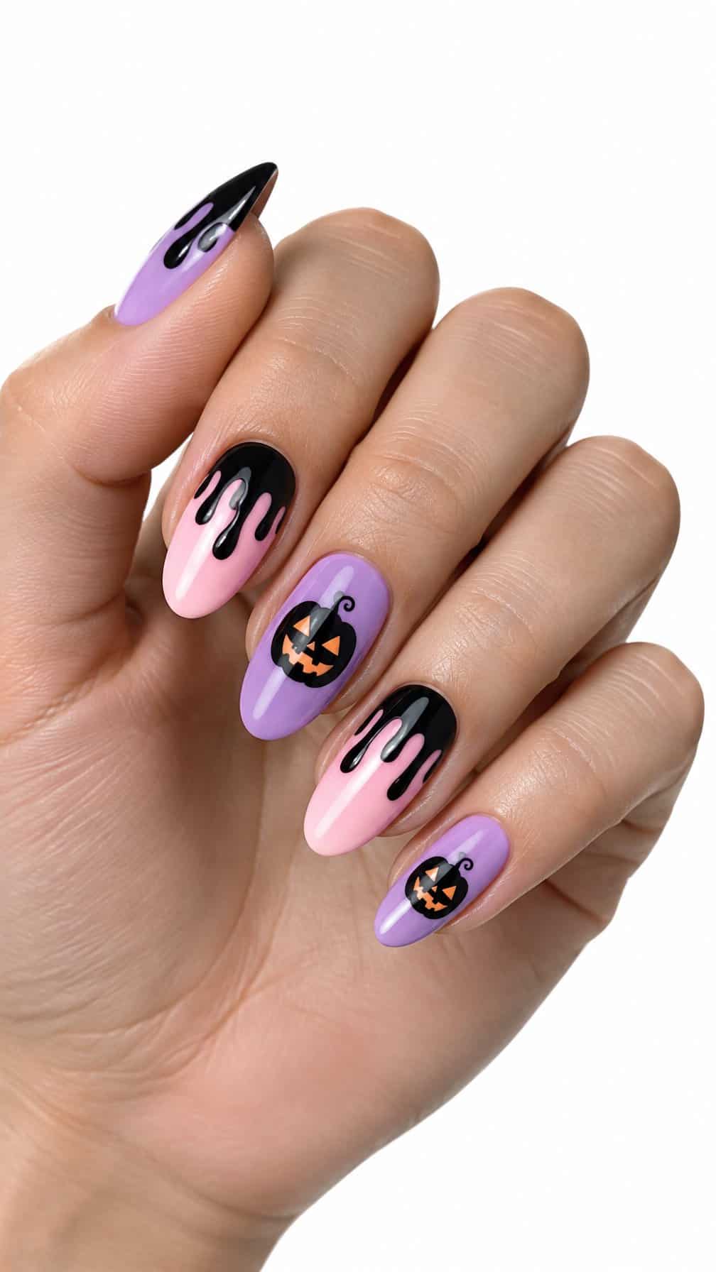 Lilac, pink, and black Halloween nails featuring drip patterns and small pumpkin faces