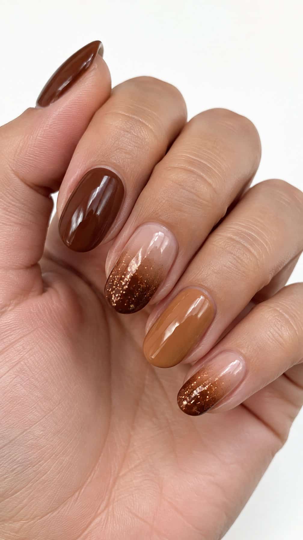 Glossy brown, caramel, and glitter-faded manicure nails