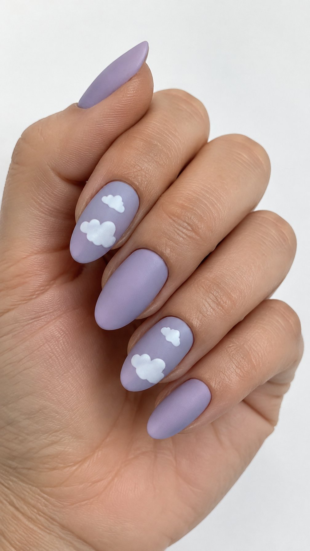 Lavender nails and small white cloud designs