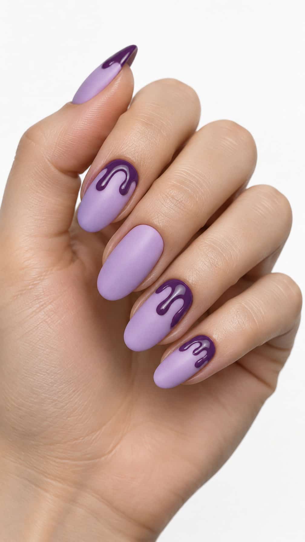 Matte lilac nails decorated with glossy purple drips