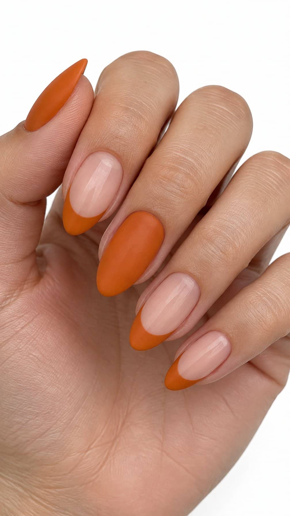 Pumpkin-orange French tip nails and solid orange nails