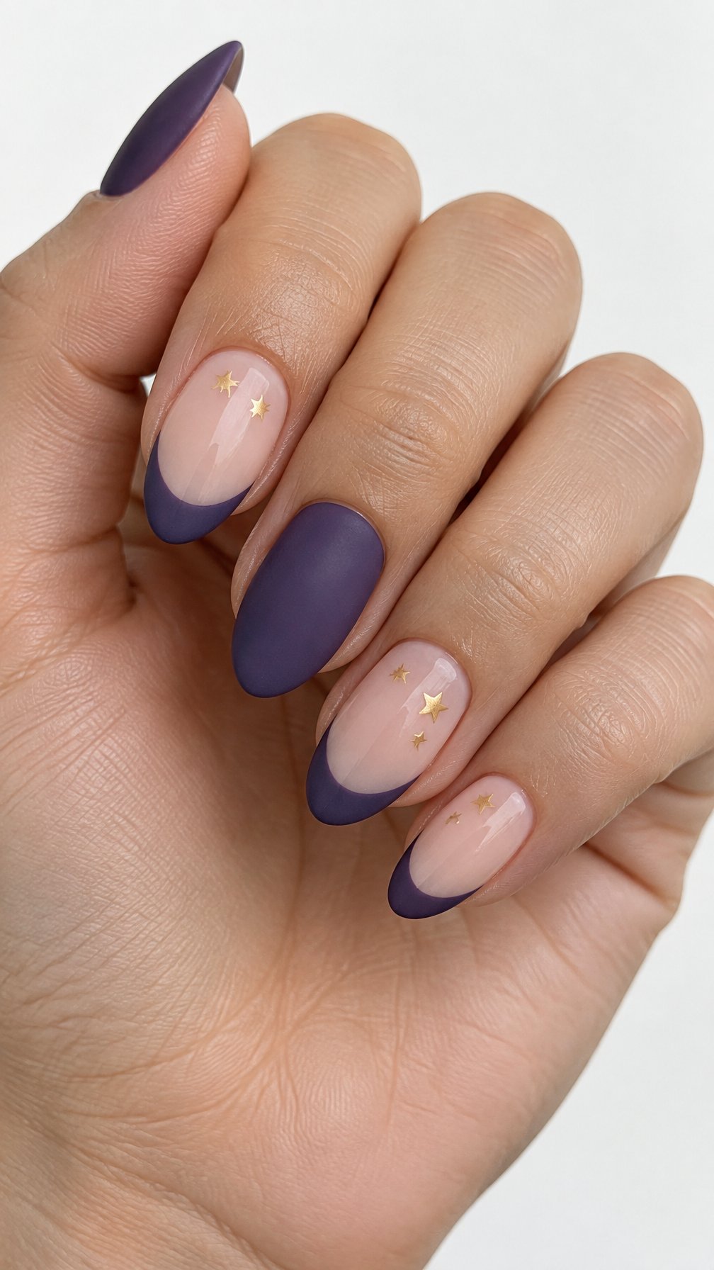 Purple French-tip nails and tiny gold star accents