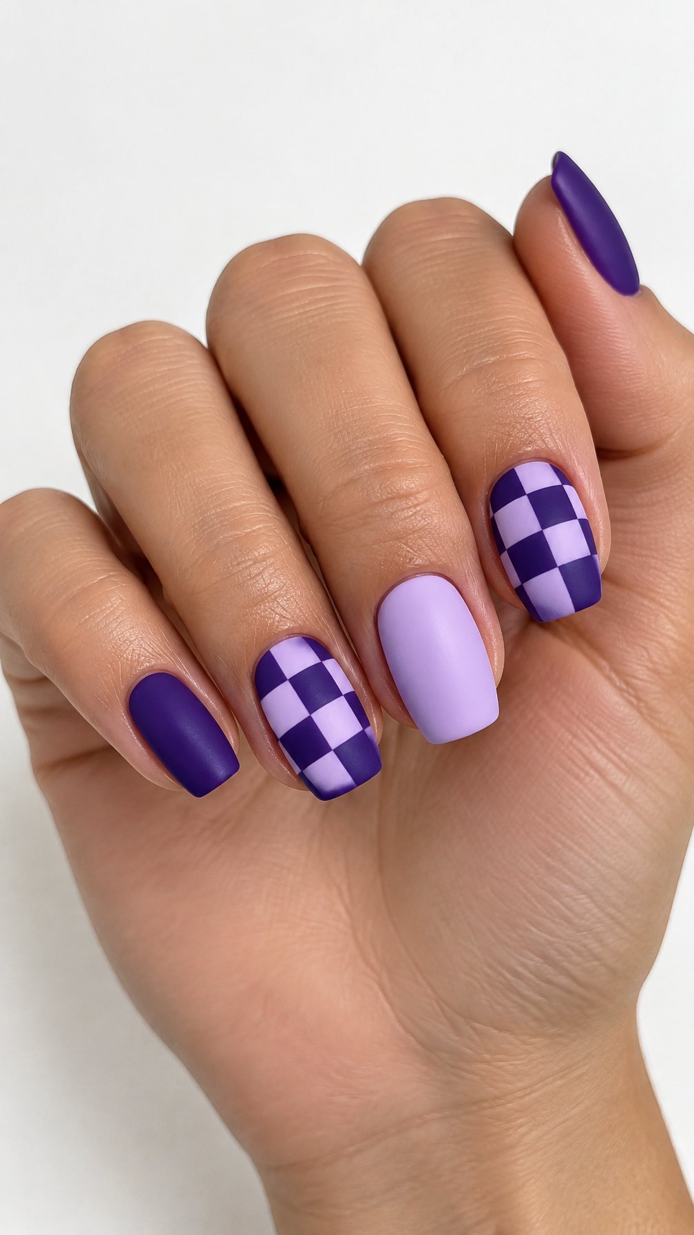 Purple and lilac checkerboard and solid-color manicured nails