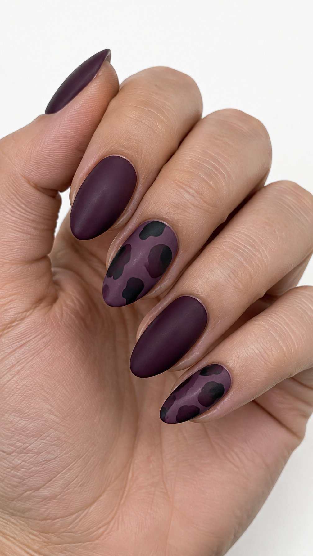 A purple and black tortoiseshell manicure
