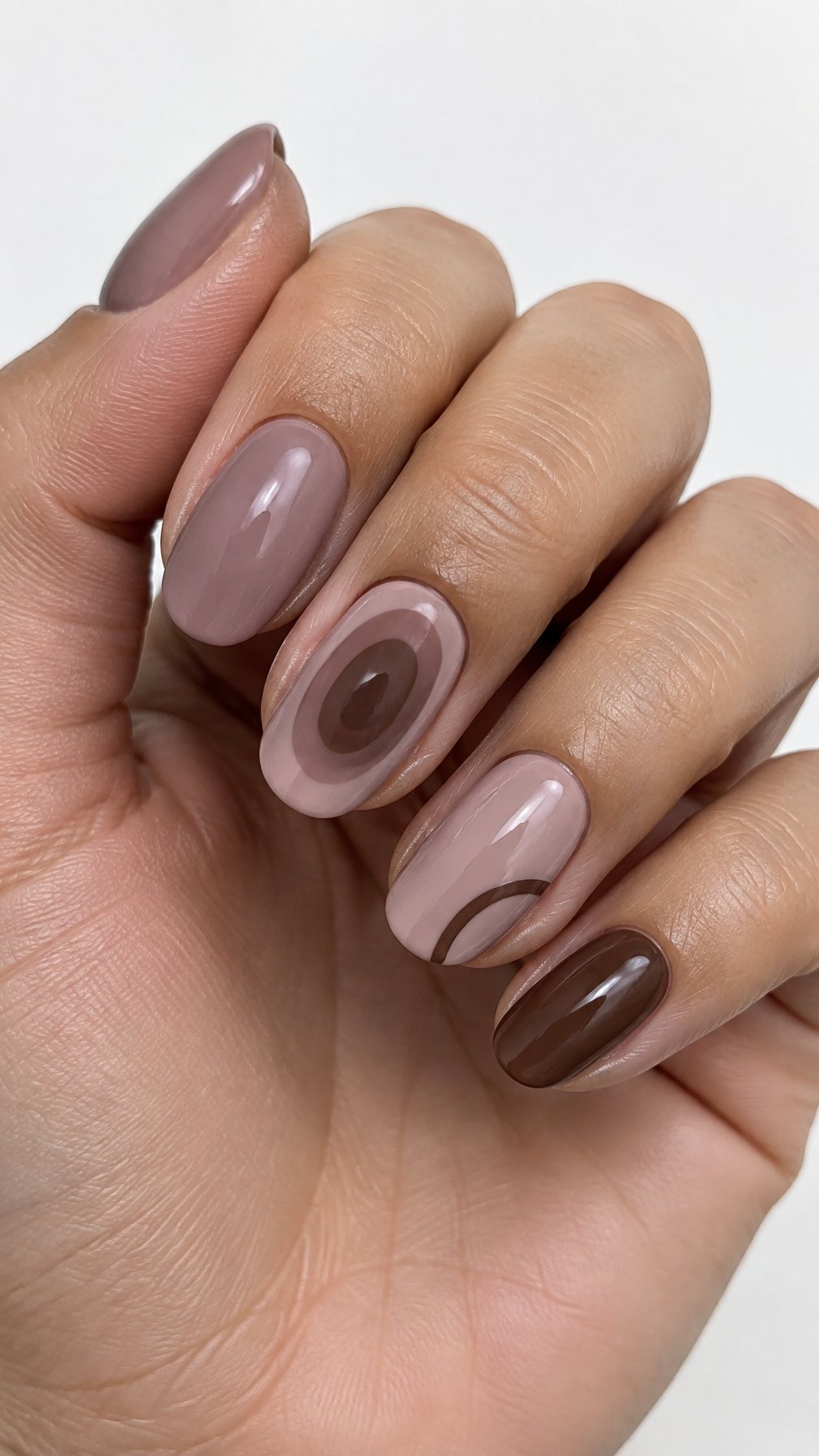Glossy mauve and brown gel-painted nails