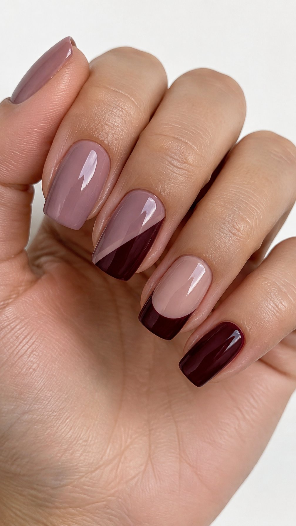 Glossy mauve and burgundy color-blocked manicure