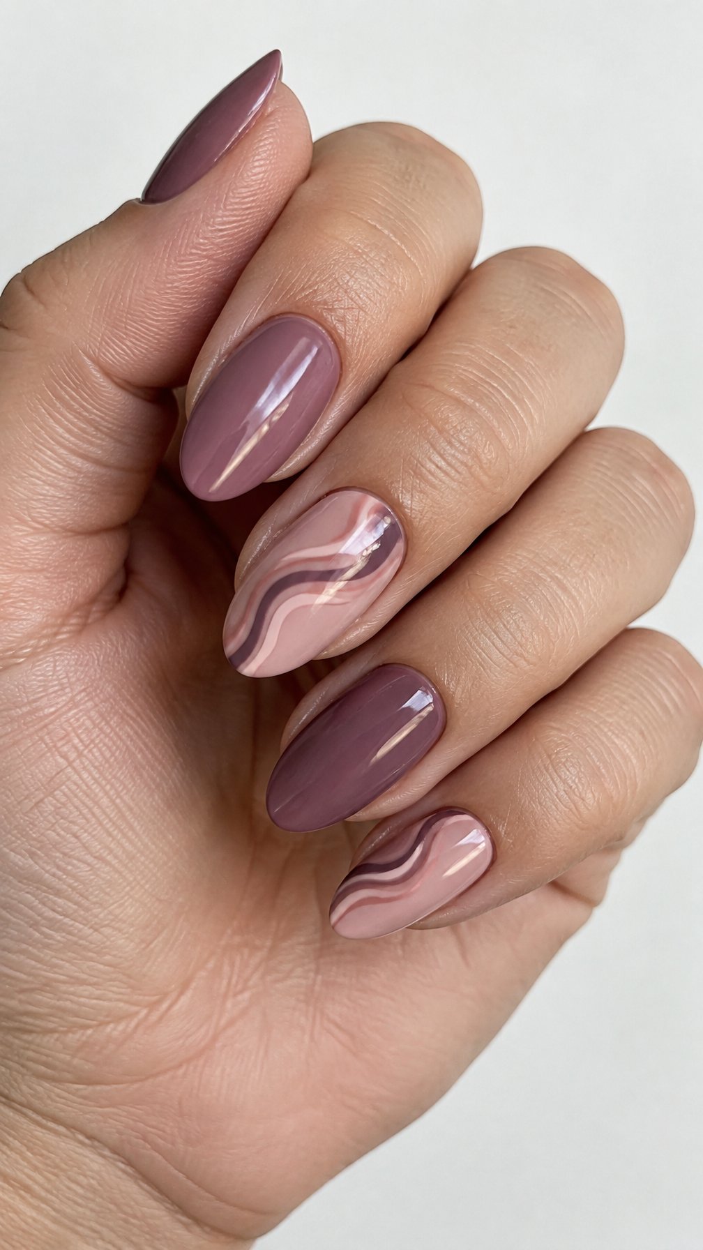Glossy mauve and rosy grape swirl gel-painted nails