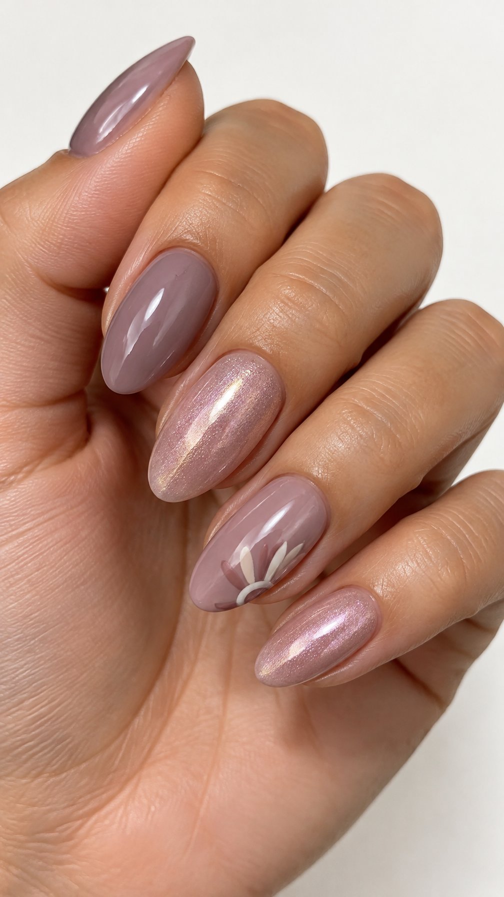 Glossy mauve gel nails, including subtle iridescent shimmer and simple painted accents