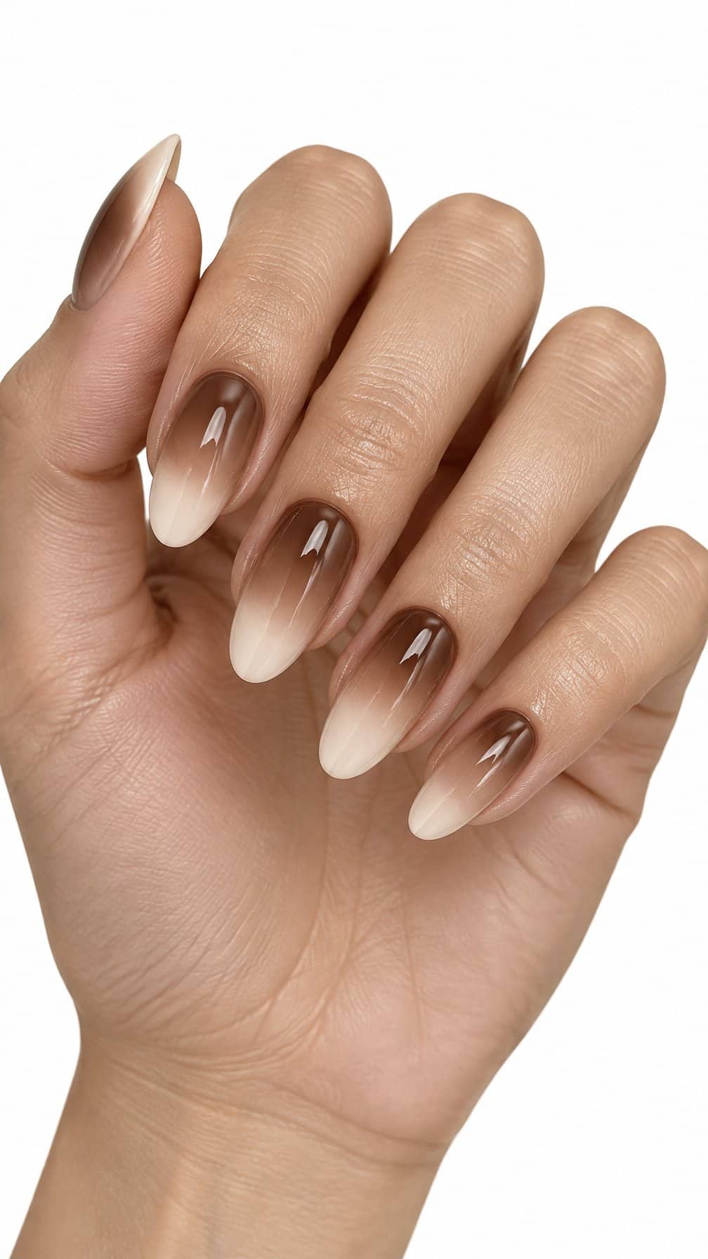 Almond-shaped nails featuring a glossy brown-to-cream ombre manicure