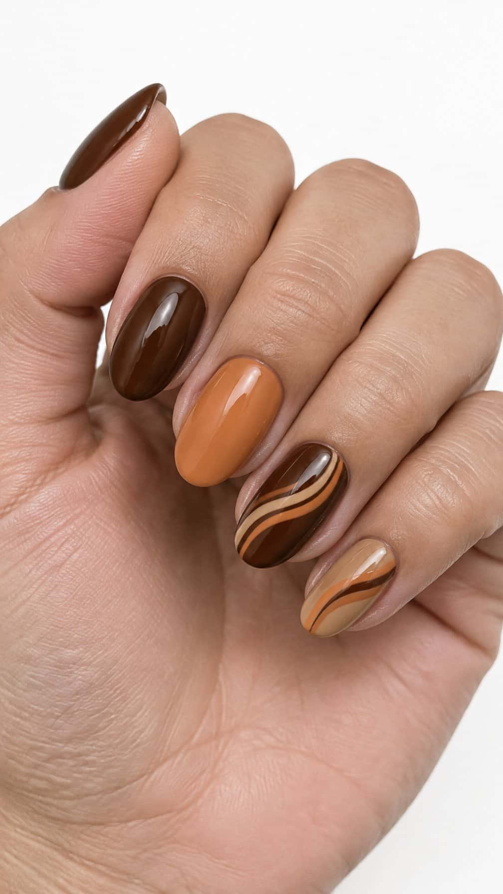 Glossy mocha brown and pumpkin orange swirled gel nails