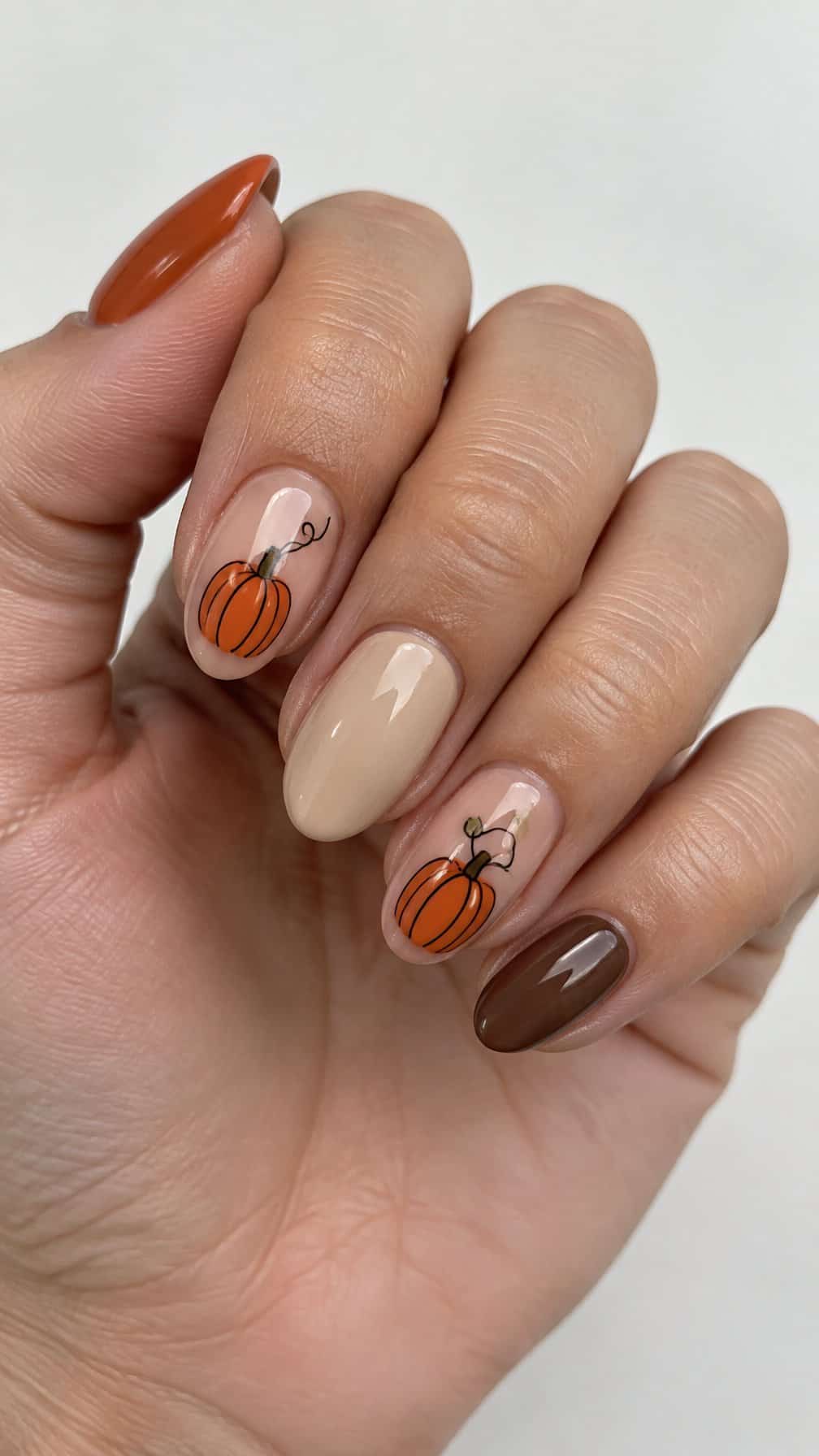 Glossy autumn-colored pumpkin nail art