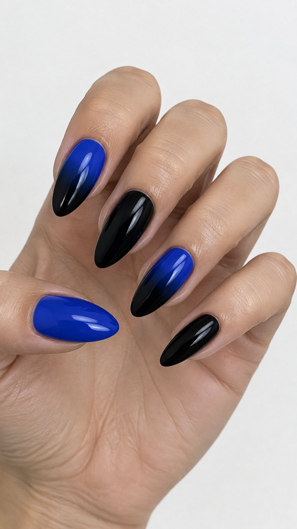 Glossy cobalt-blue and black almond-shaped gel nails