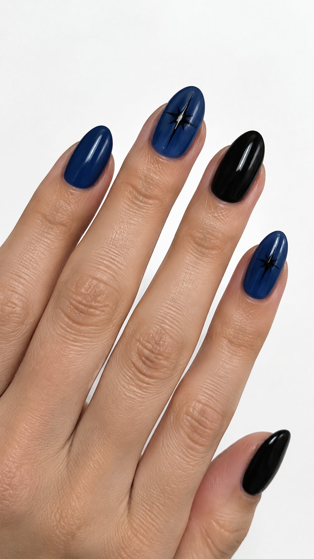 Glossy navy and black starburst-patterned nails