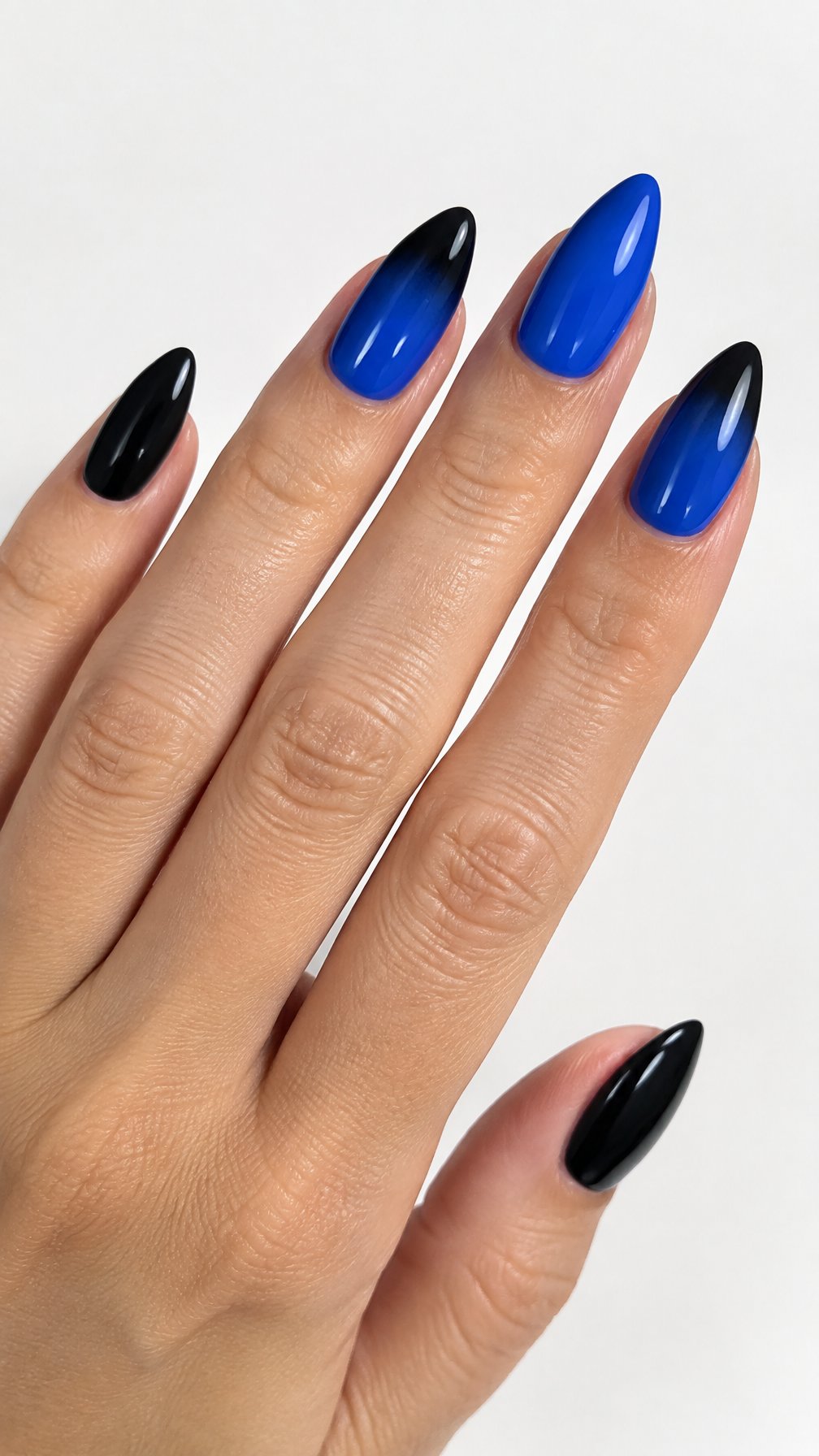 Glossy black and cobalt-blue almond-shaped manicure