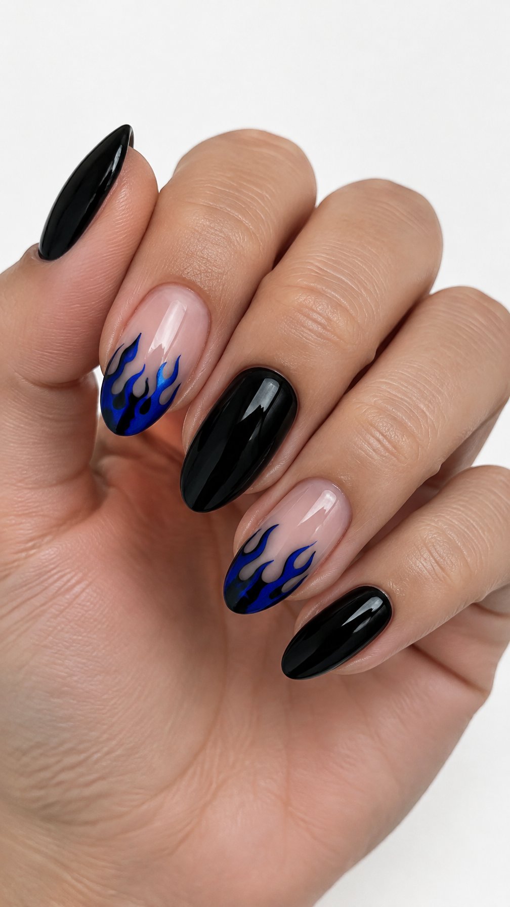 Glossy black nails and sapphire blue flame designs on several tips