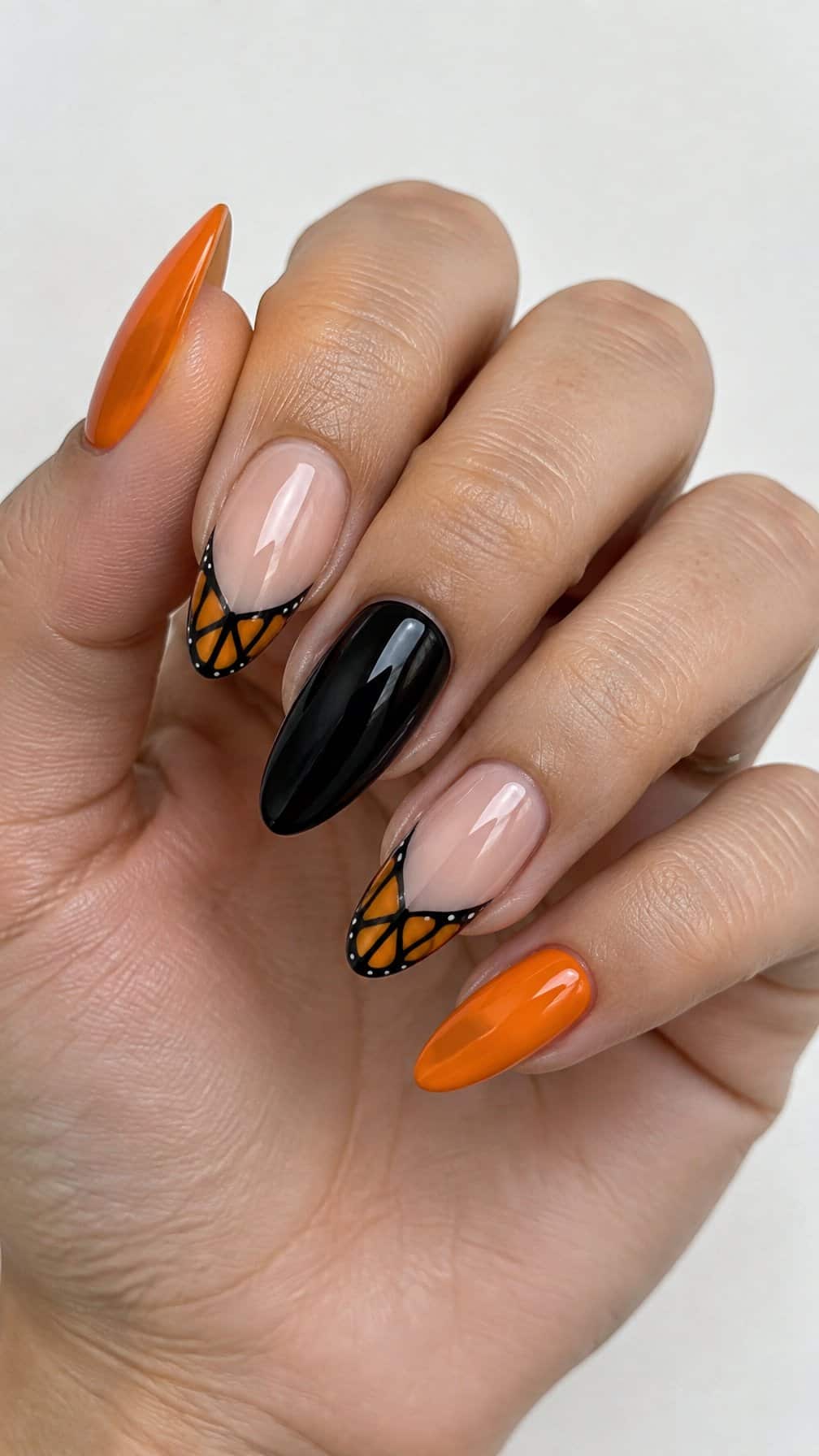 Glossy orange and black butterfly French-tip nails