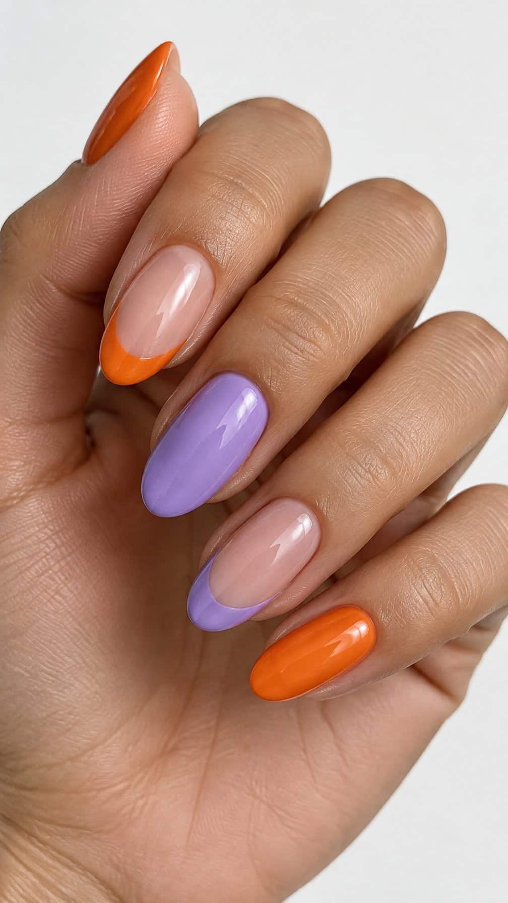 Glossy orange and lavender French-tip nails