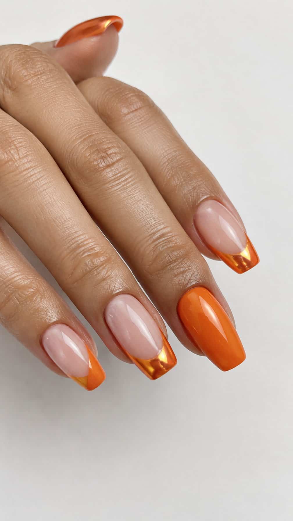 A glossy orange French-tip manicure