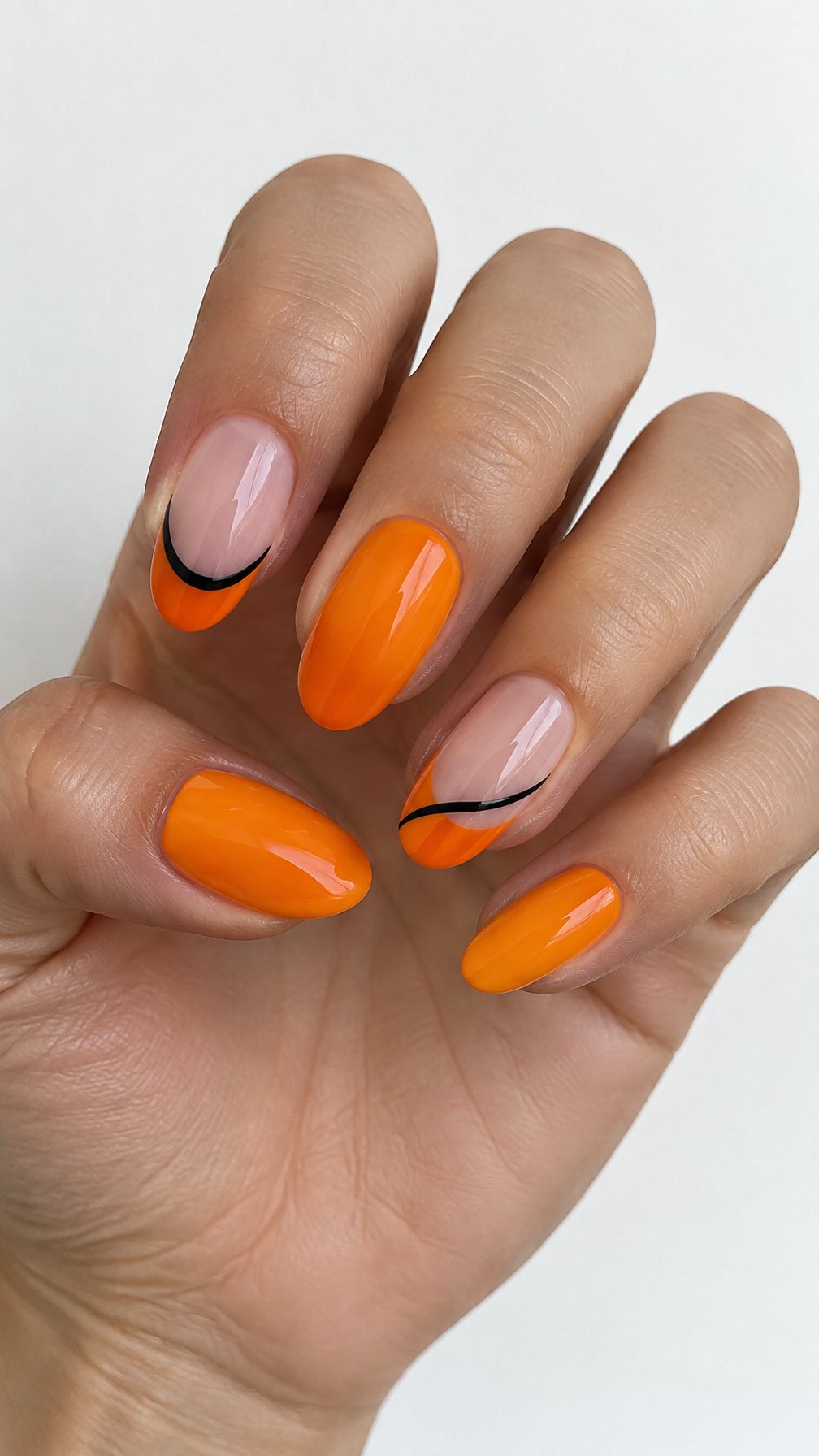 Glossy orange French tip nails accented by black lines, photographed