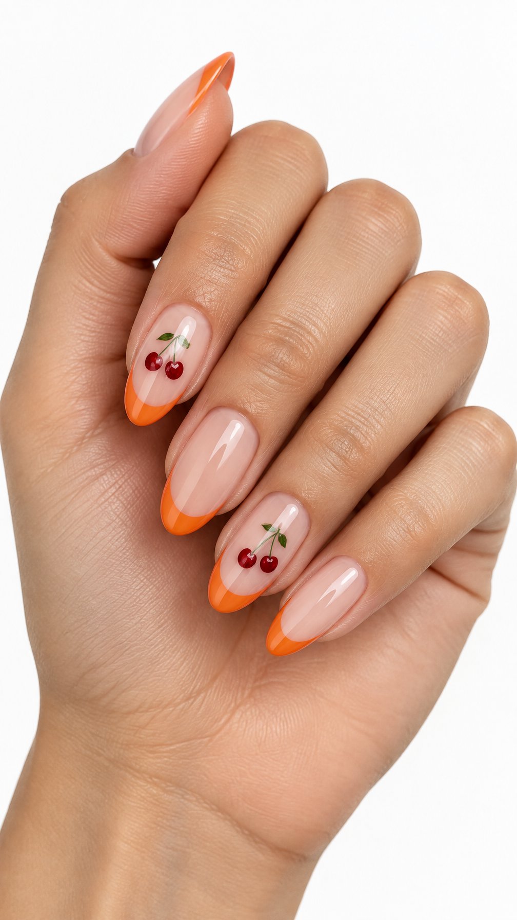 Glossy orange French-tip nails decorated with tiny cherry designs