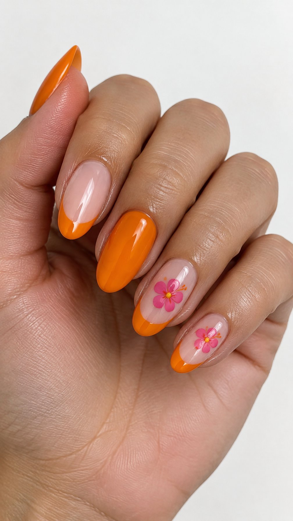 Glossy orange French tip nails and pink hibiscus flower designs