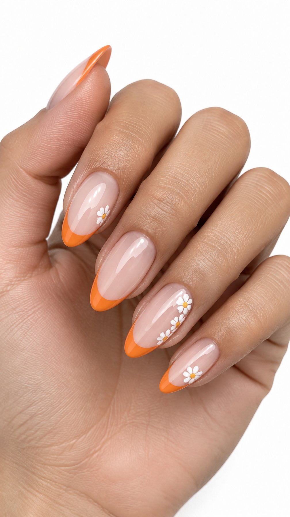 Glossy orange French tip nails decorated with small white daisies