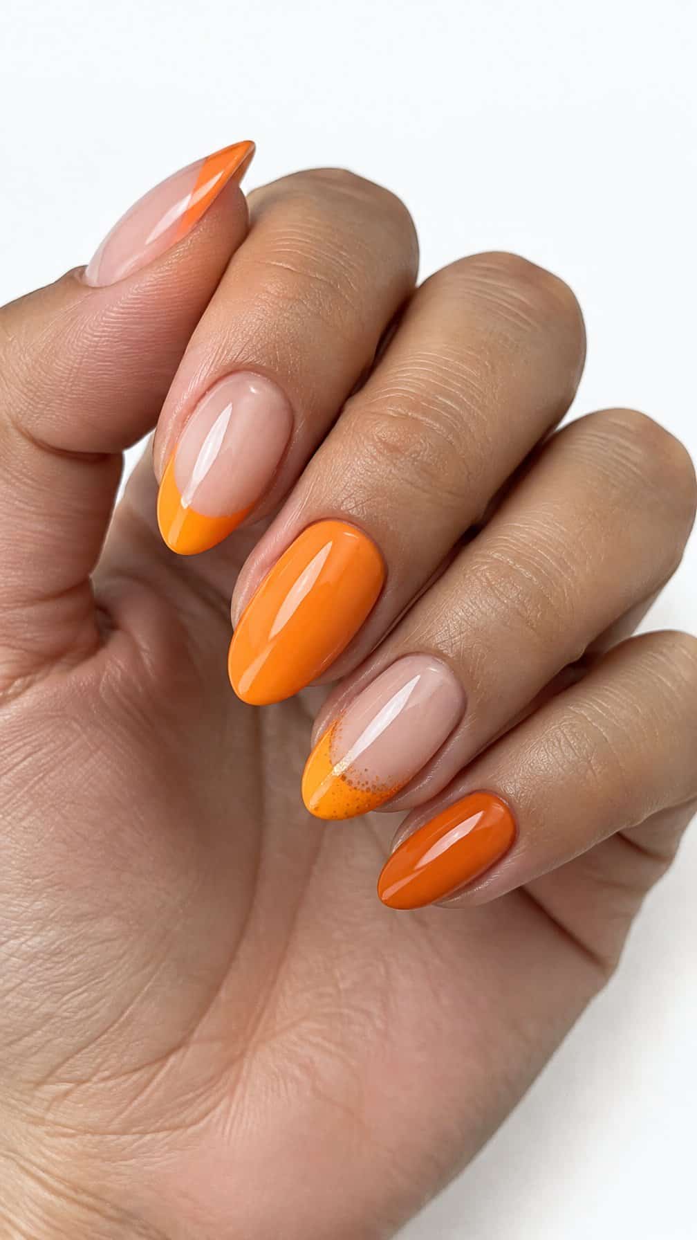 Glossy orange French tip nails and orange glitter accents