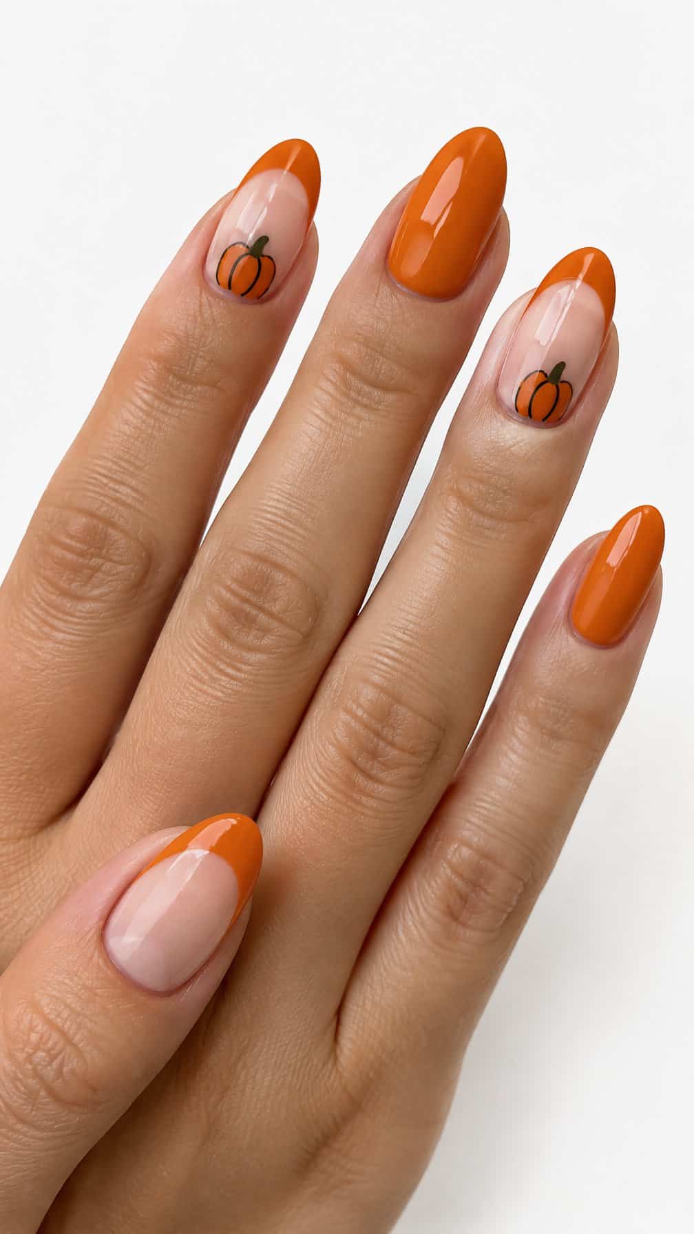 Glossy orange pumpkin-themed French tip manicure