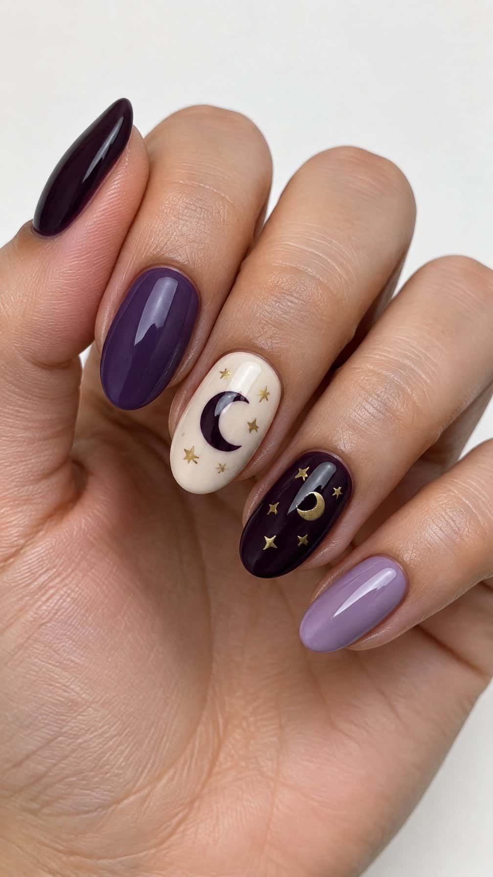Glossy purple Halloween-themed moon and star nails